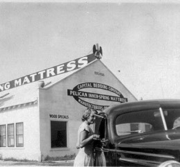 Our new building opening attracted local celebrities and the news media. Shown is a picture of the new building with an old car in front of it.